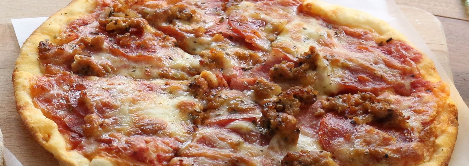 Gourmet pizza with sausage and bacon
